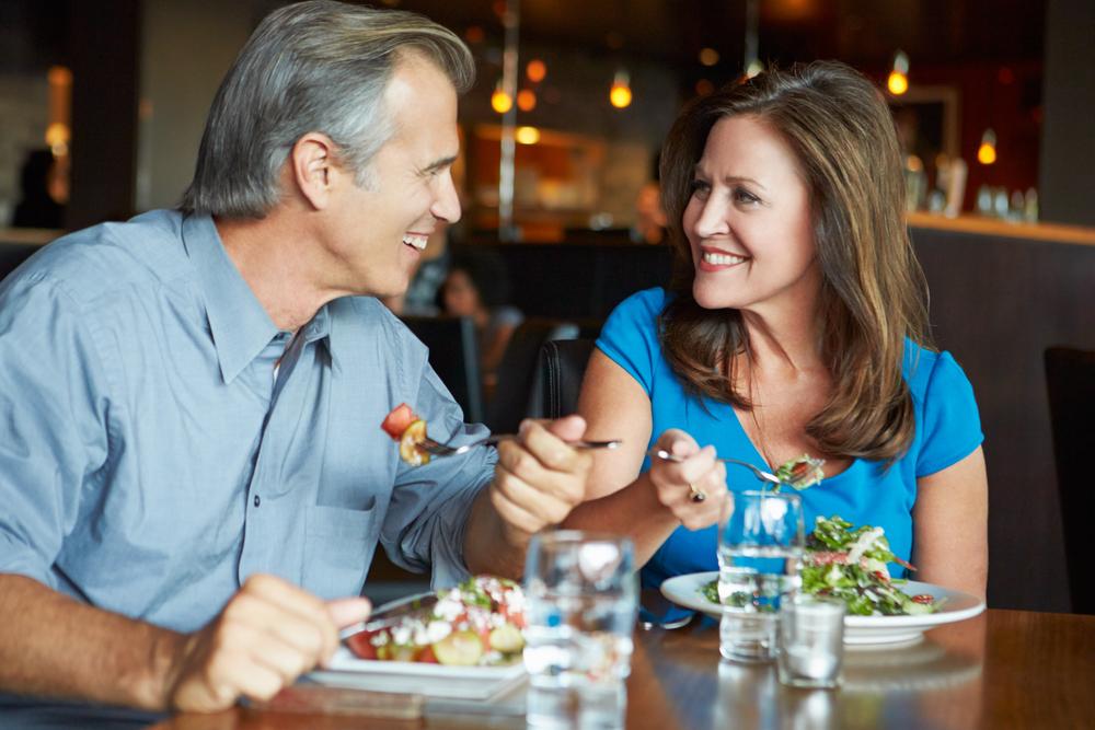 Older couple eating out at restaurant