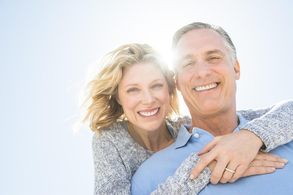Older couple smiling implants